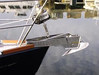 Midnight Yacht Photos Pics Bow of a 2005 Sabre 386 sailboat with anchor and calm water reflection.