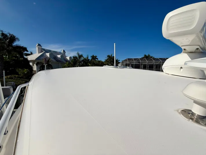  Yacht Photos Pics Tiara Yachts 3500 Sovran 2008 on calm waters near coastal house.