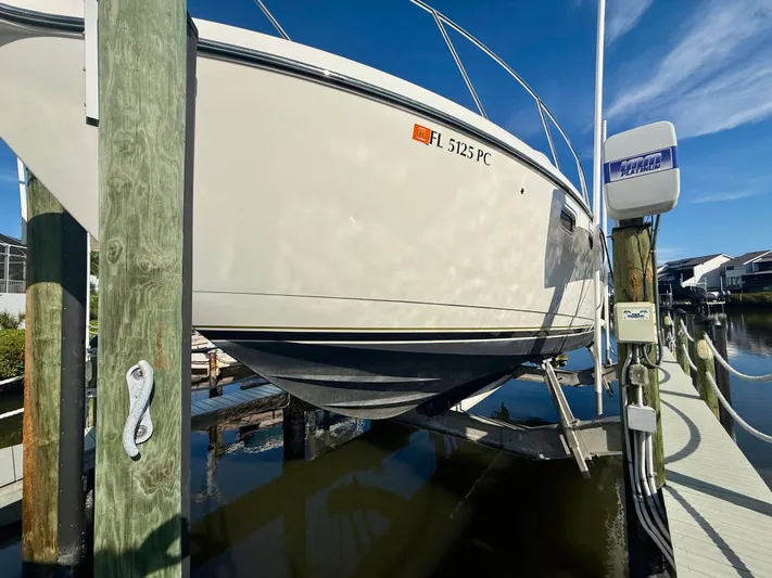  Yacht Photos Pics 2008 Tiara Yachts 3500 Sovran on a boat lift at the dock.