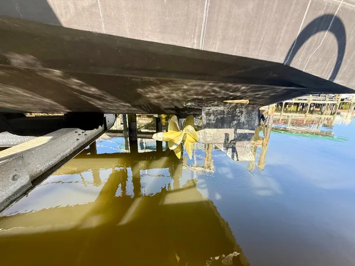  Yacht Photos Pics Underside of a 2008 Tiara Yachts 3500 Sovran with propeller in water.