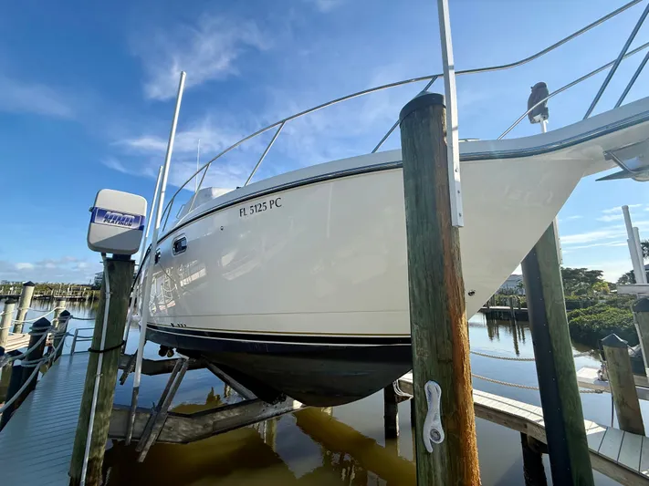  Yacht Photos Pics 2008 Tiara Yachts 3500 Sovran on boat lift at dock.