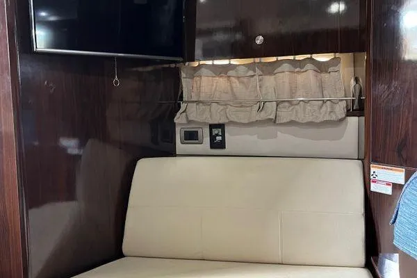  Yacht Photos Pics Interior of 2017 Sea Ray Sundancer 350 with TV, sofa, and curtains.