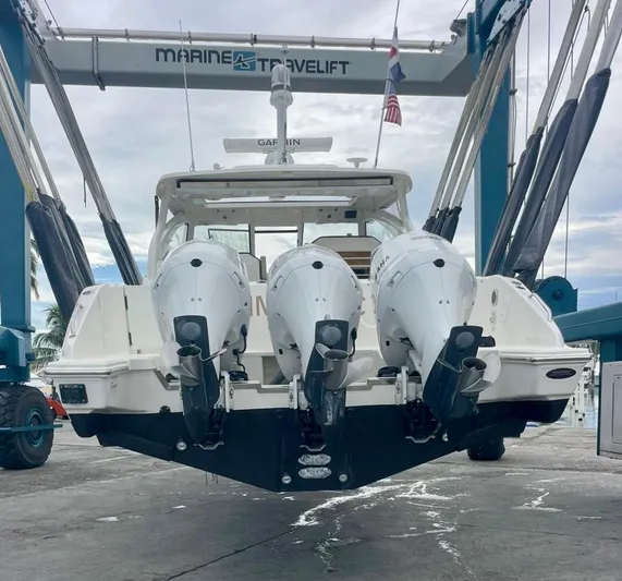  Yacht Photos Pics 2020 Pursuit DC 365 boat with triple outboard engines on a lift.