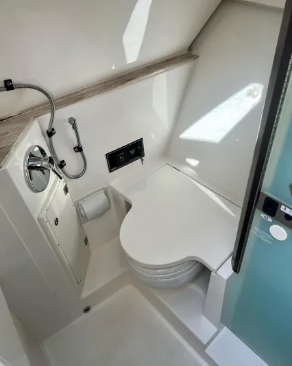  Yacht Photos Pics 2020 Pursuit DC 365 boat bathroom with modern fixtures and compact design.