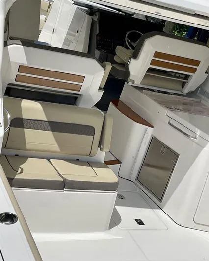  Yacht Photos Pics 2020 Pursuit DC 365 boat interior with beige seating and modern design.