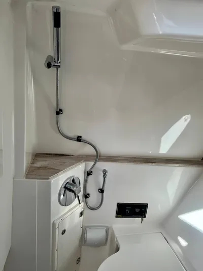  Yacht Photos Pics 2020 Pursuit DC 365 boat interior with shower and control panel.