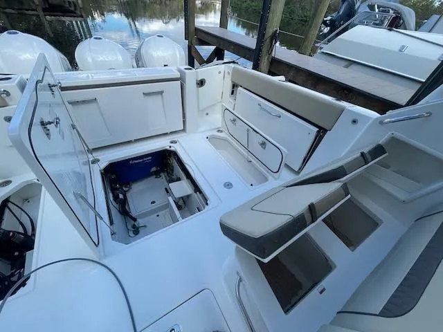  Yacht Photos Pics 2020 Pursuit DC 365 boat interior with open storage compartments and seating.