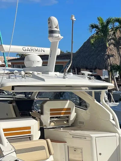  Yacht Photos Pics 2020 Pursuit DC 365 boat with Garmin radar, docked under clear blue sky.