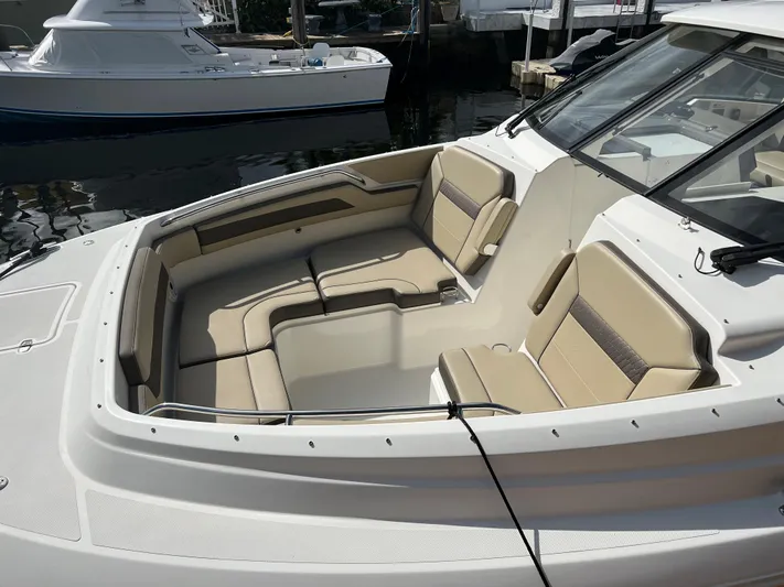  Yacht Photos Pics 2020 Pursuit DC 365 boat with spacious seating in a marina setting.
