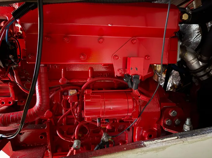 Imagine Yacht Photos Pics Red engine of a 1990 J Boats J/44 sailboat, showcasing detailed components.