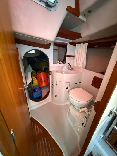 Imagine Yacht Photos Pics 1990 J Boats J/44 yacht bathroom with sink, toilet, and storage space.