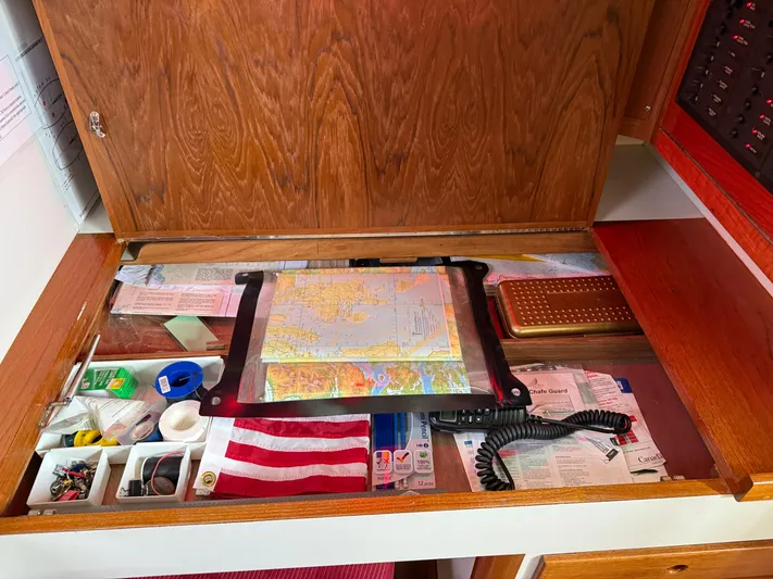 Imagine Yacht Photos Pics Navigation station on a 1990 J Boats J/44 with map, tools, and American flag.