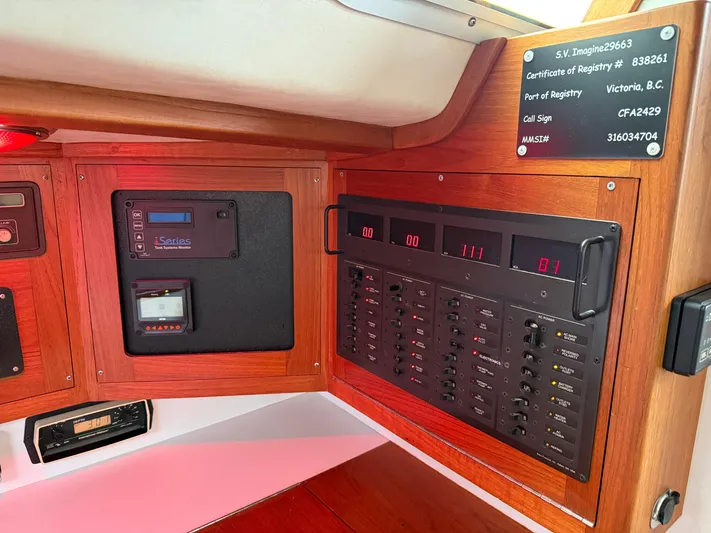 Imagine Yacht Photos Pics Electrical control panel inside a 1990 J Boats J/44 sailboat, featuring various switches and displays.