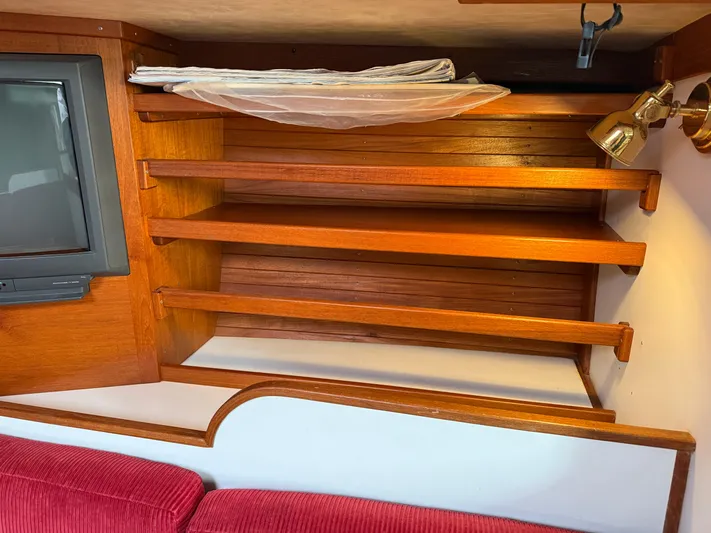 Imagine Yacht Photos Pics Interior of 1990 J Boats J/44 showing wooden shelves and red seating.