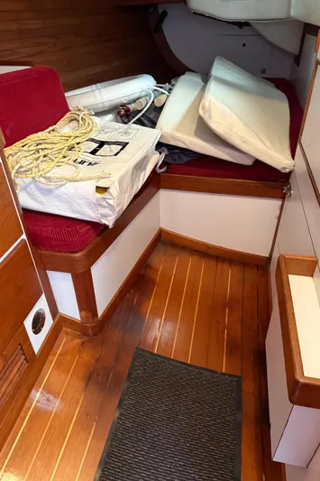 Imagine Yacht Photos Pics Interior of 1990 J Boats J/44 sailboat with wooden flooring and red seating.