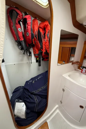 Imagine Yacht Photos Pics Interior of 1990 J Boats J/44 with life jackets and storage area.