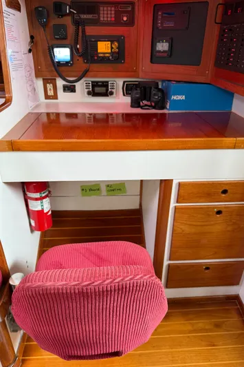 Imagine Yacht Photos Pics Navigation station of a 1990 J Boats J/44 with red chair and communication equipment.