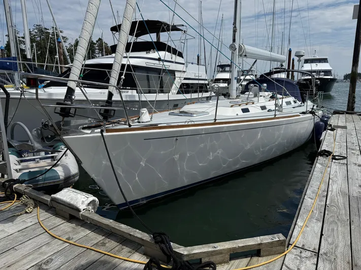 Imagine Yacht Photos Pics 1990 J Boats J/44 sailboat docked at marina, surrounded by other vessels.