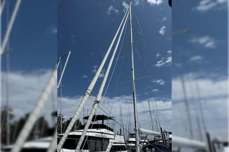 Imagine Yacht Photos Pics Sailboat mast of 1990 J Boats J/44 against a clear blue sky.