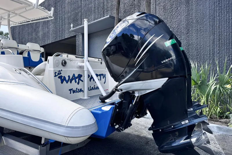  Yacht Photos Pics 2014 Airship 330 boat with Verado outboard motor, docked near a building.