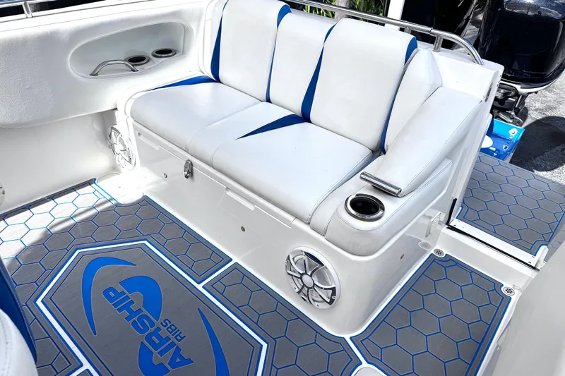  Yacht Photos Pics Interior of 2014 Airship 330 boat with white seating and hexagonal patterned flooring.
