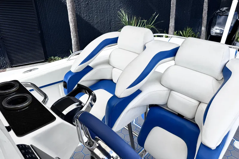  Yacht Photos Pics Luxury seating on a 2014 Airship 330 boat, featuring white and blue cushioned seats.