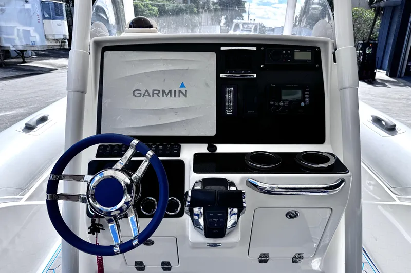  Yacht Photos Pics Control panel of 2014 Airship 330 boat featuring Garmin navigation system and steering wheel.