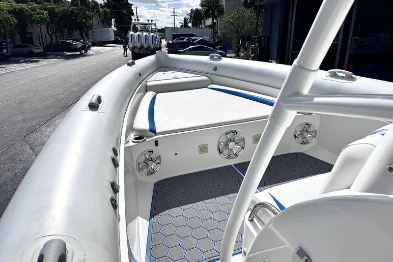  Yacht Photos Pics Airship 330 boat interior, 2014 model, featuring white seating and hexagonal floor design.