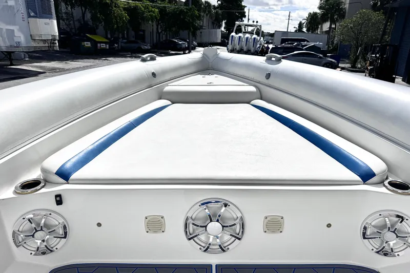  Yacht Photos Pics Airship 330 boat interior, 2014 model, featuring white and blue seating with speakers.