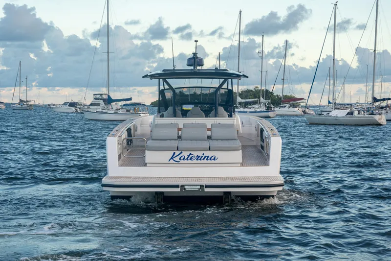 Katerina Yacht Photos Pics 2021 Pardo Yachts 43 cruising in a marina with sailboats in the background.