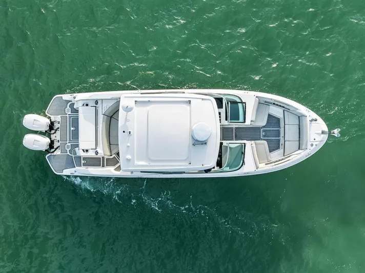  Yacht Photos Pics Aerial view of 2021 Sea Ray 350 SLX OB boat on green water.