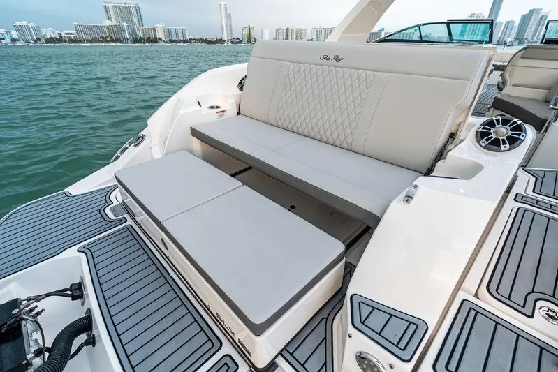  Yacht Photos Pics 2021 Sea Ray 350 SLX OB boat with luxurious seating and waterfront city view.