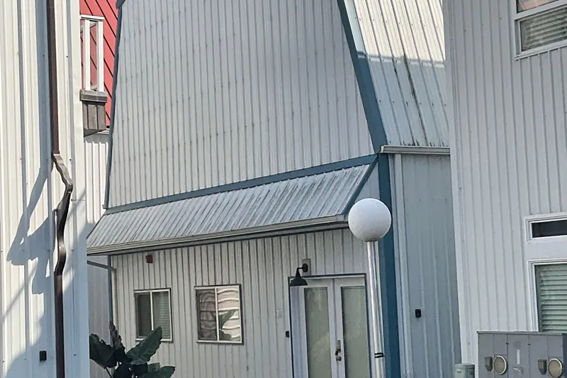  Yacht Photos Pics Modern custom boathouse with metal siding, built in 1995, featuring unique architectural design.