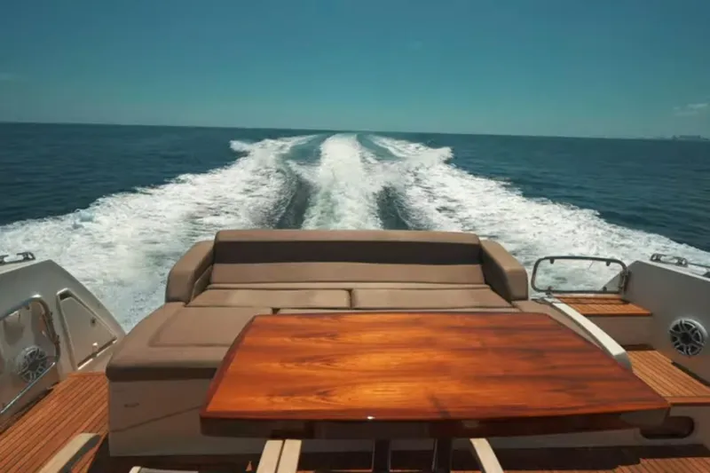  Yacht Photos Pics Luxury yacht Prestige 550 S cruising on open sea, 2013 model, with elegant deck seating.