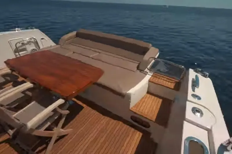  Yacht Photos Pics Luxury 2013 Prestige 550 S yacht deck with seating and table, overlooking the ocean.