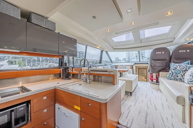  Yacht Photos Pics Luxurious interior of 2013 Prestige 550 S yacht with modern kitchen and seating area.