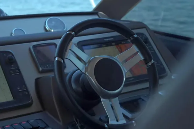  Yacht Photos Pics Steering wheel and dashboard of 2013 Prestige 550 S yacht, featuring navigation screens.