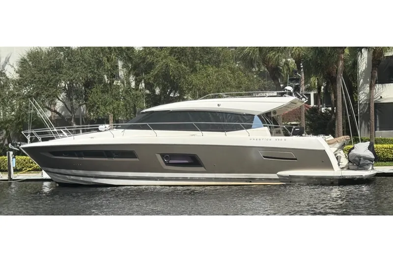  Yacht Photos Pics 2013 Prestige 550 S yacht docked by lush greenery.
