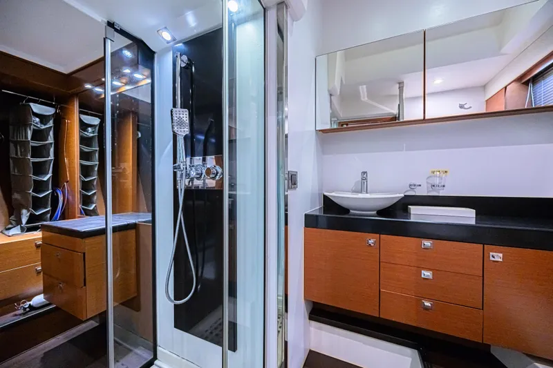  Yacht Photos Pics Luxurious bathroom interior of 2013 Prestige 550 S yacht with modern fixtures and wood cabinetry.