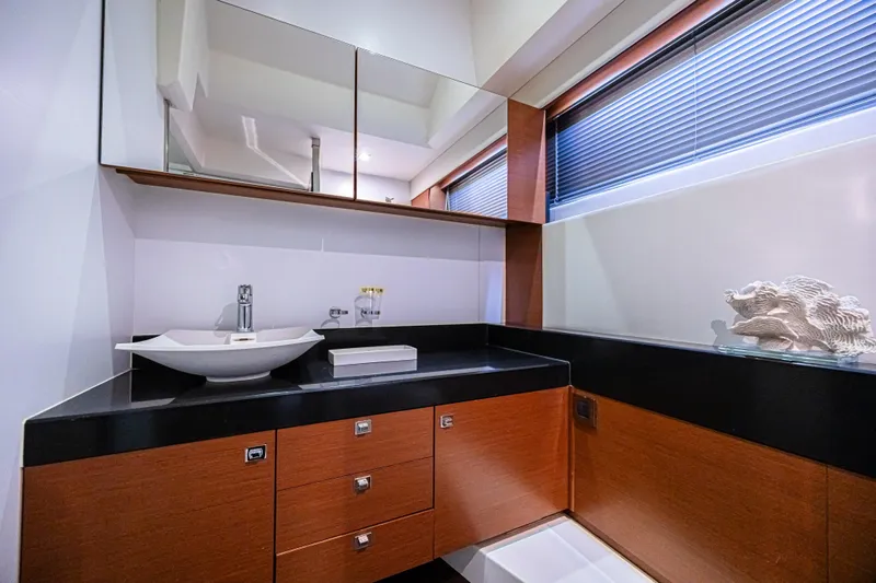  Yacht Photos Pics Luxurious bathroom interior of 2013 Prestige 550 S yacht with modern sink and wooden cabinetry.