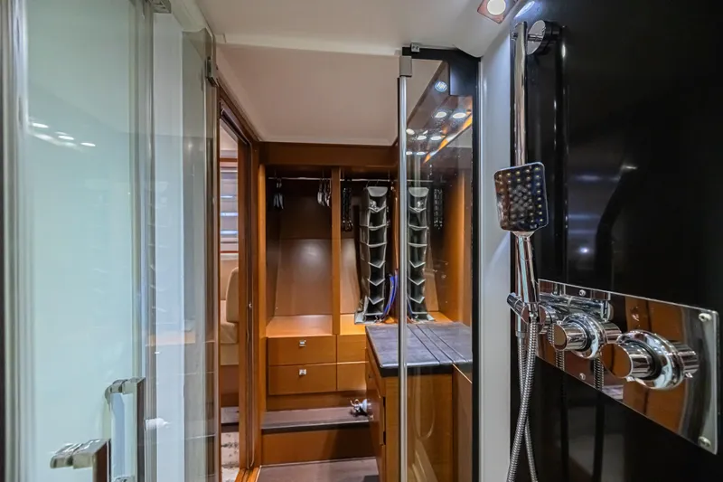  Yacht Photos Pics Luxurious bathroom interior of 2013 Prestige 550 S yacht with modern shower and wooden cabinetry.