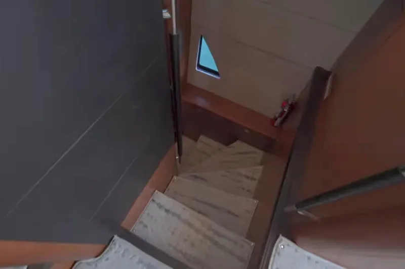  Yacht Photos Pics Staircase inside 2013 Prestige 550 S yacht, featuring wooden steps and modern design.