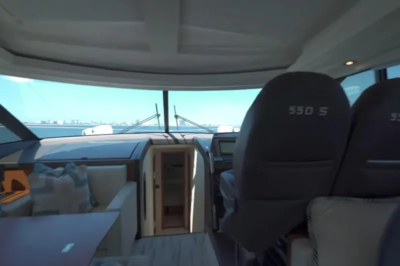  Yacht Photos Pics Interior view of 2013 Prestige 550 S yacht, featuring helm and seating area.