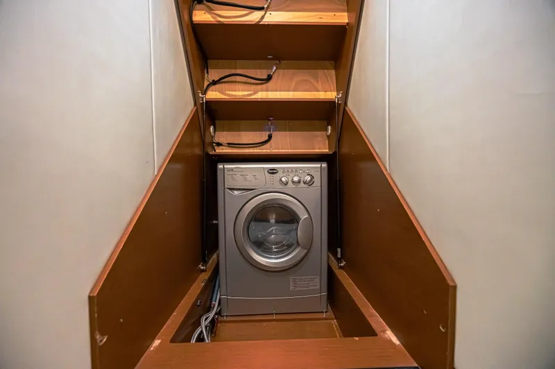  Yacht Photos Pics Compact laundry area with washing machine in 2013 Prestige 550 S yacht.