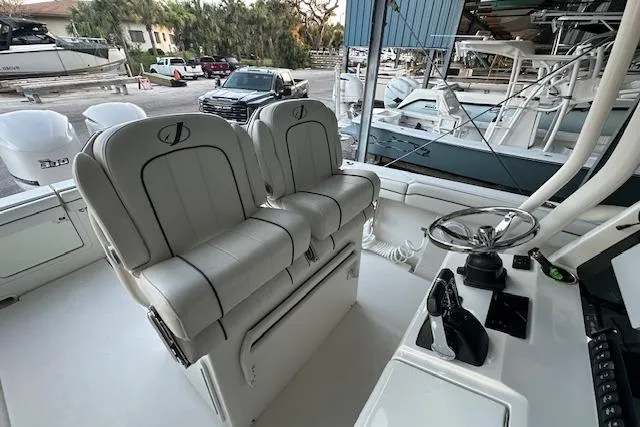  Yacht Photos Pics 2015 Jupiter 30 CC boat interior with dual captain's chairs and control panel.
