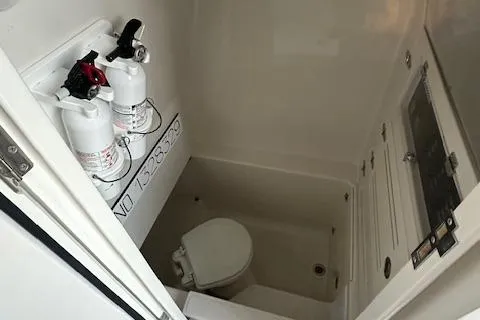  Yacht Photos Pics 2015 Jupiter 30 CC boat bathroom with fire extinguishers and toilet.