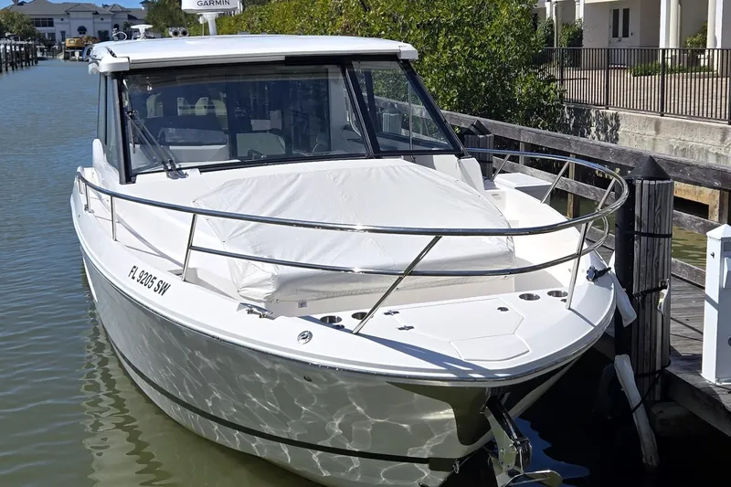  Yacht Photos Pics 2021 Regal 36 XO boat docked in a marina, featuring sleek design and modern amenities.