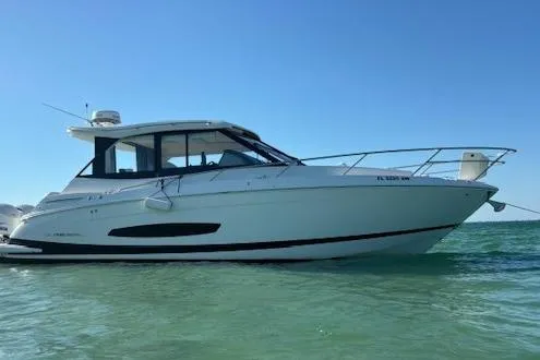  Yacht Photos Pics 2021 Regal 36 XO boat on clear water under blue sky.