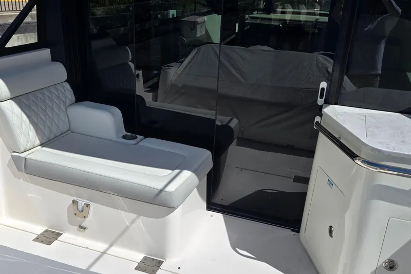  Yacht Photos Pics 2021 Regal 36 XO yacht interior with white seating and glass door.
