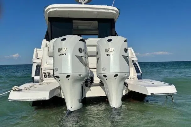  Yacht Photos Pics 2021 Regal 36 XO boat with twin Yamaha V8 engines in shallow water.